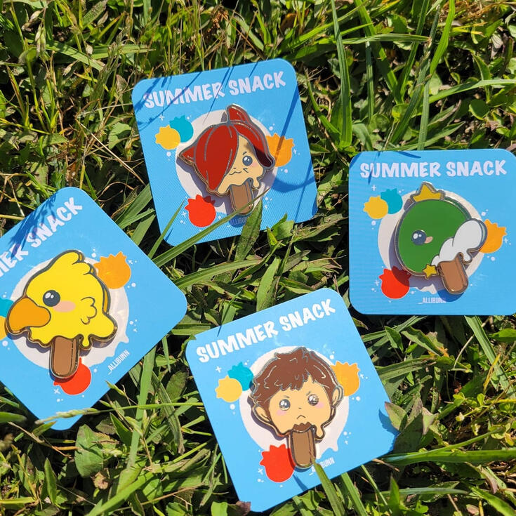 Popsicle Pins four enamel pins on blue backing cards. the four pins are designed to look like melty popsicles. four pins are chocobo, graha, king tonberry, and ardbert