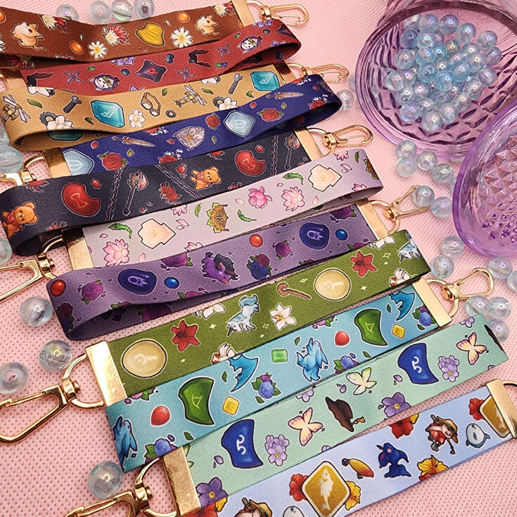 FFXIV Lanyards photograph of multiple wrist lanyards. designs are inspired by ffxiv job classes.