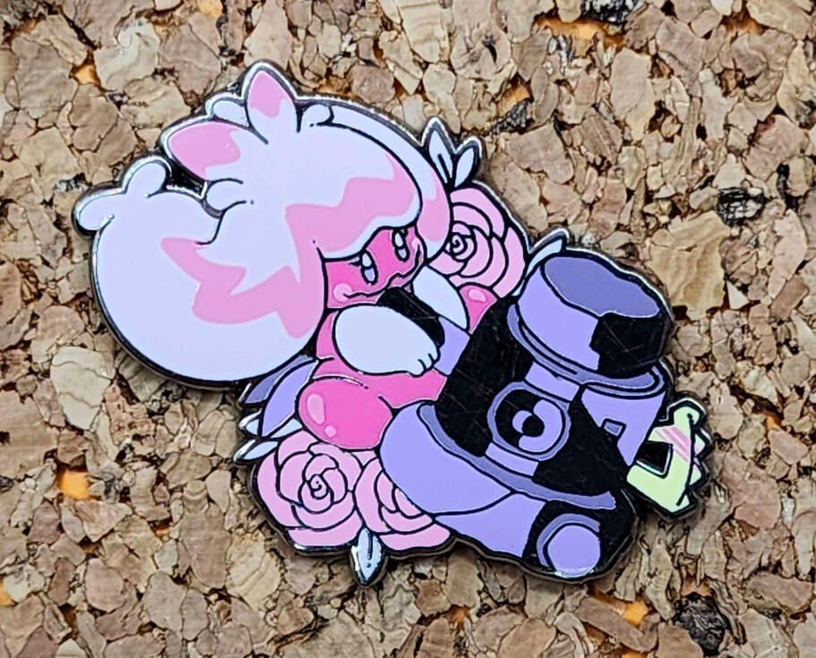 Tinkaton Enamel Pin Photograph of a tinkaton enamel pin. the pin is pink and purple with tinkaton smashing her hammer downwards